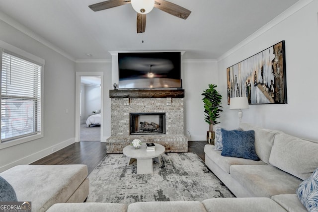 living room with a fireplace, crown molding, wood-type flooring, and ceiling fan