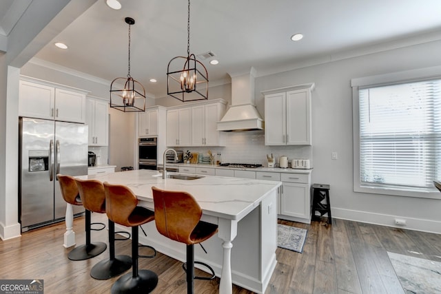 kitchen with stainless steel appliances, sink, custom exhaust hood, and white cabinets