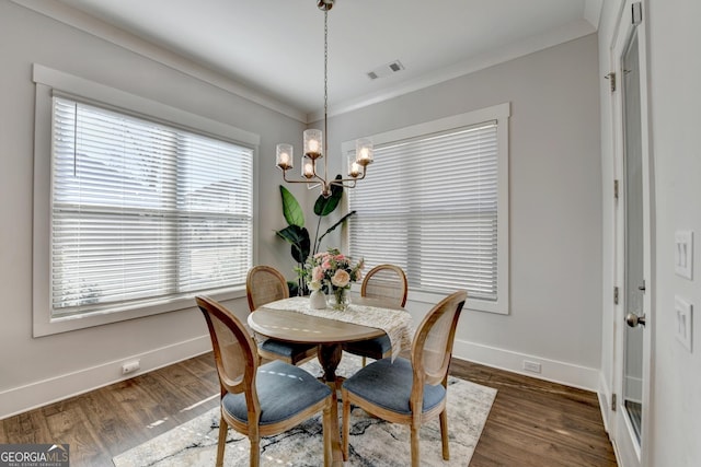 dining area featuring dark hardwood / wood-style flooring, plenty of natural light, and ornamental molding