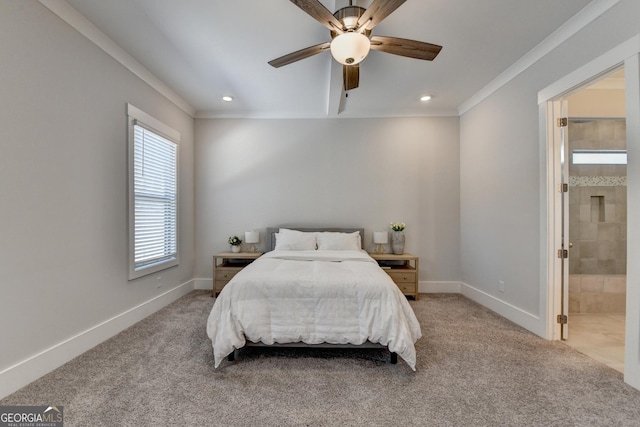 bedroom with ceiling fan, ensuite bath, ornamental molding, and light colored carpet