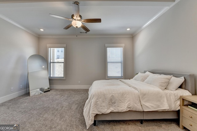 bedroom featuring multiple windows, ceiling fan, crown molding, and light carpet