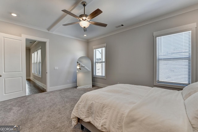 bedroom featuring dark colored carpet, crown molding, and ceiling fan