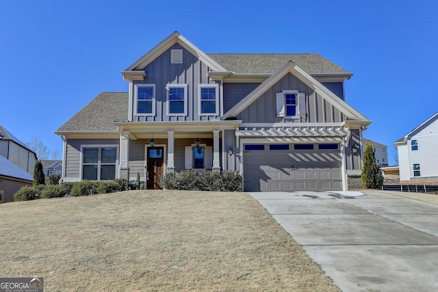 craftsman-style house with a garage, covered porch, and a front lawn