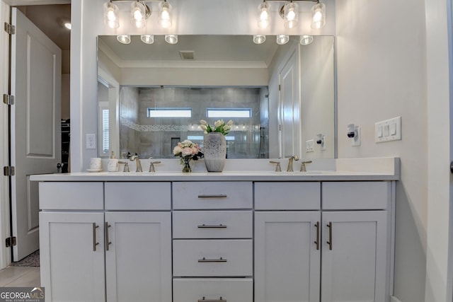 bathroom with tiled shower, vanity, and tile patterned flooring