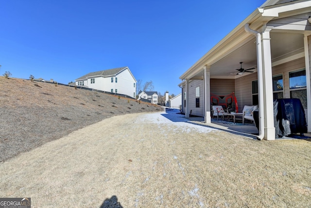 view of yard with ceiling fan and a patio area