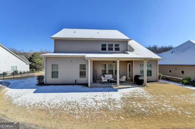 rear view of house with ceiling fan and a patio area