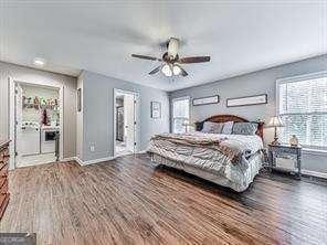 bedroom featuring ceiling fan and dark wood-type flooring