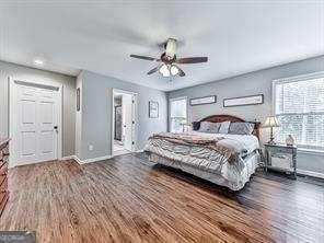 bedroom featuring ceiling fan and dark hardwood / wood-style floors