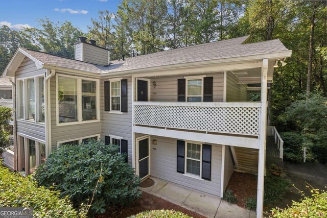 1608 Vicksburg Pl, Atlanta, GA 30350 - back of house featuring a chimney and a shingled roof