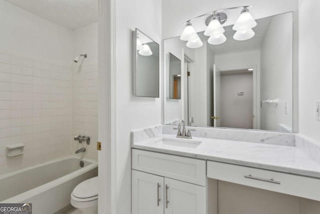 full bathroom with vanity, toilet, and tiled shower / bath combo