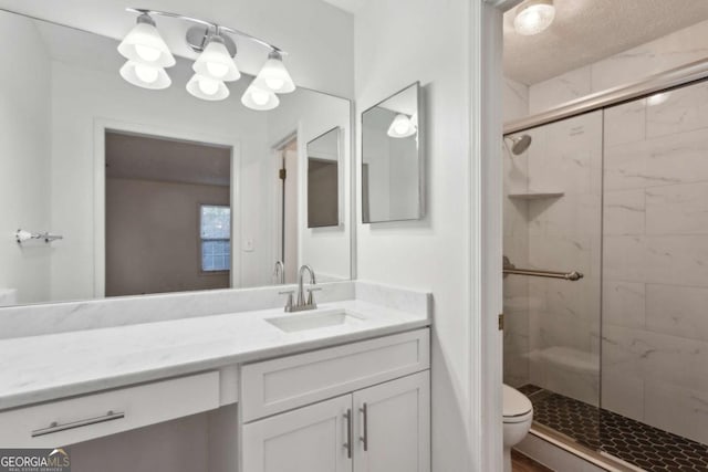 bathroom with toilet, an enclosed shower, and vanity