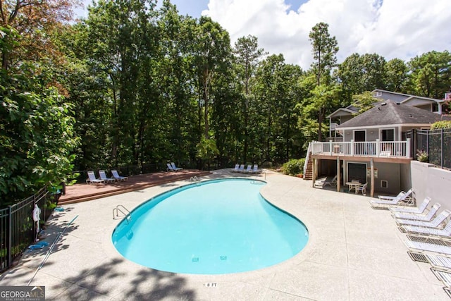 view of swimming pool with a deck and a patio