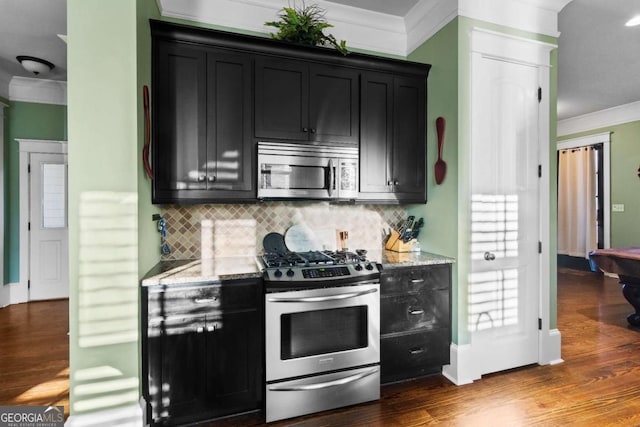 kitchen featuring backsplash, dark hardwood / wood-style floors, light stone countertops, and appliances with stainless steel finishes