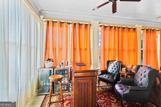 sitting room with ceiling fan and crown molding