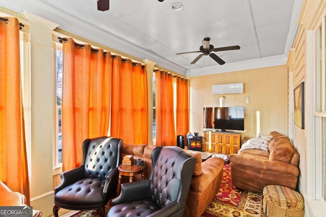 living room with ceiling fan and ornamental molding