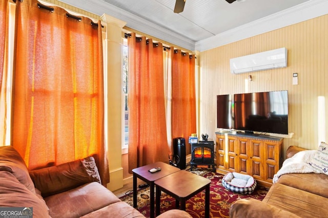 living room featuring ceiling fan, a wood stove, ornamental molding, and a wall mounted AC