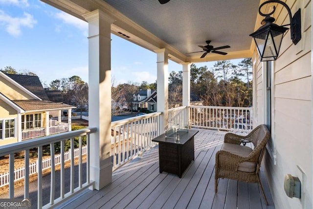 wooden terrace featuring ceiling fan and a porch