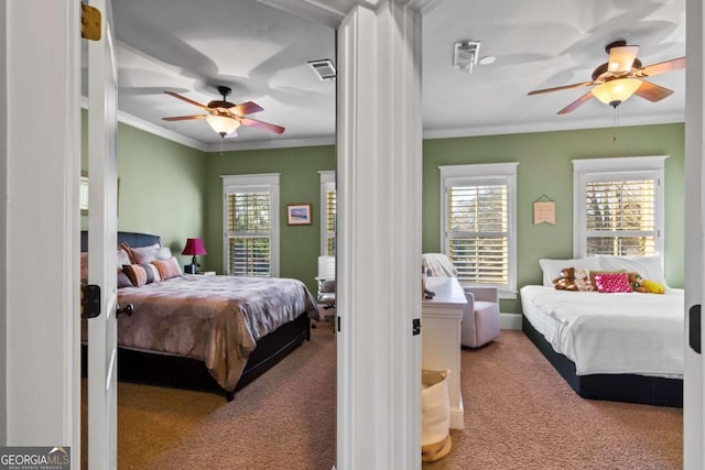 carpeted bedroom with crown molding and ceiling fan