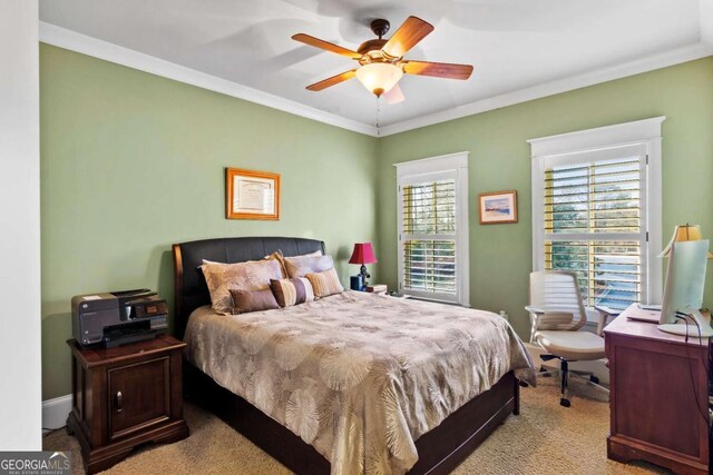 carpeted bedroom featuring crown molding and ceiling fan