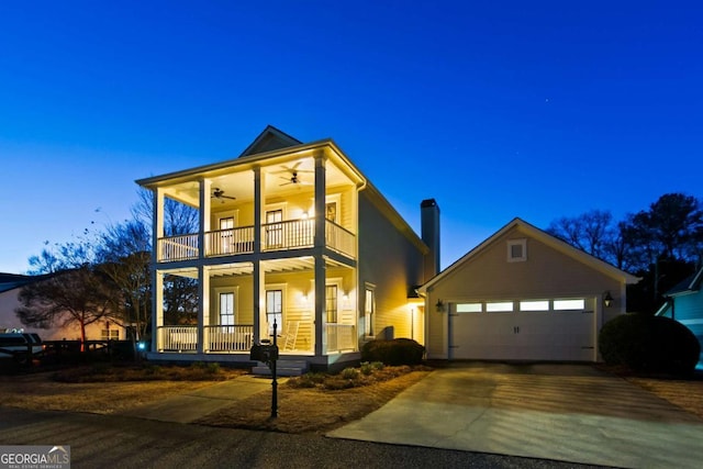 view of front of house featuring a balcony, a garage, and covered porch