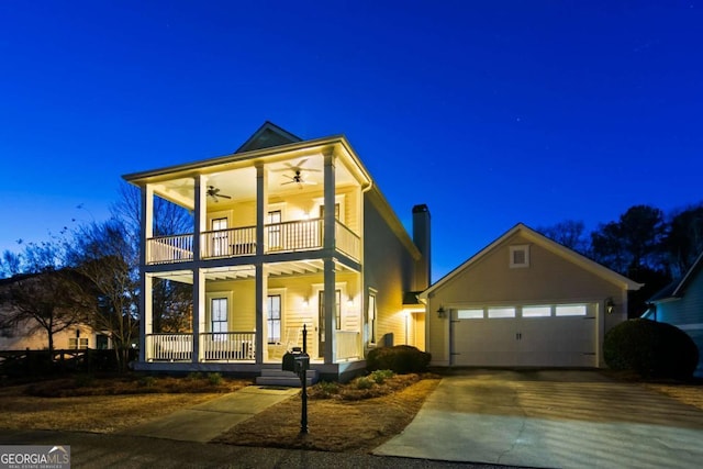 view of front of property featuring covered porch, a balcony, and a garage