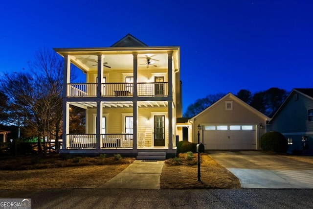 view of front facade with a balcony, a garage, a porch, and ceiling fan