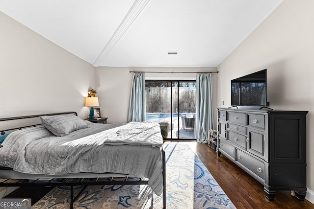 bedroom with dark wood-type flooring, access to exterior, and lofted ceiling