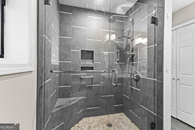 bathroom with a shower with shower door