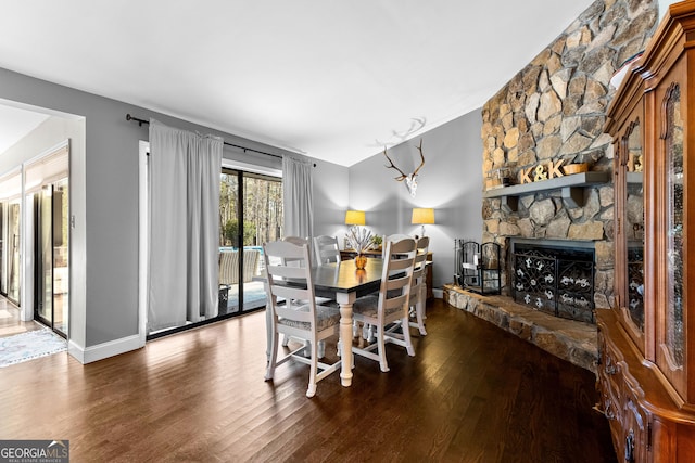 dining area featuring hardwood / wood-style flooring and a fireplace