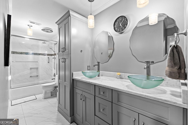 full bathroom featuring ornamental molding, bath / shower combo with glass door, toilet, and vanity