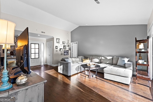 living room with dark hardwood / wood-style floors and lofted ceiling