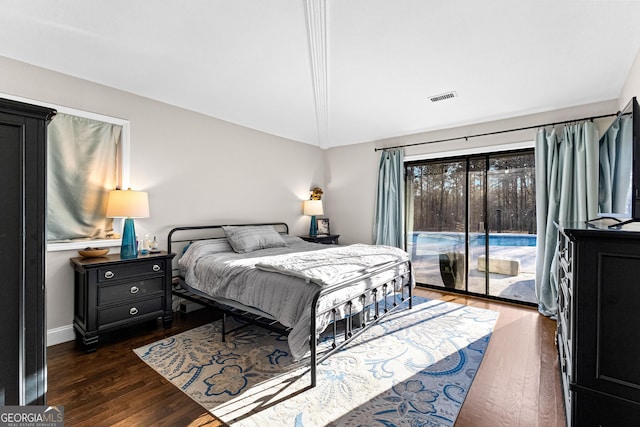 bedroom featuring access to outside, dark wood-type flooring, and lofted ceiling