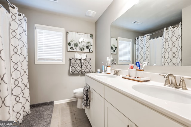 bathroom featuring vanity, tile patterned floors, and toilet