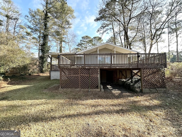 back of property with a deck and a yard