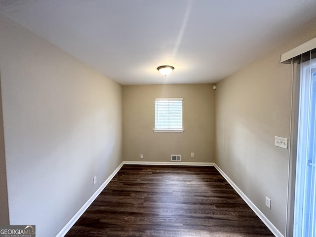 unfurnished room featuring dark hardwood / wood-style flooring