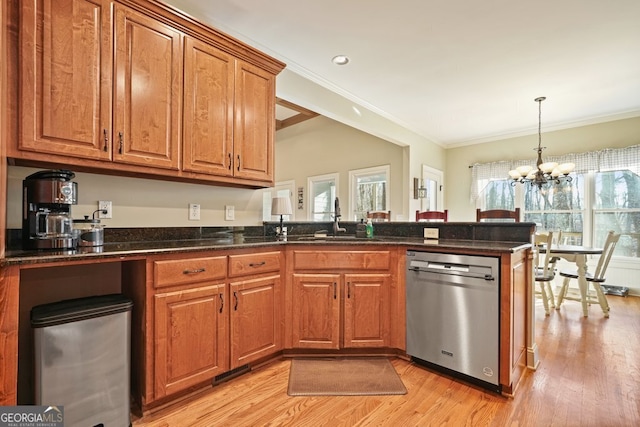 kitchen featuring sink, a wealth of natural light, crown molding, and stainless steel dishwasher