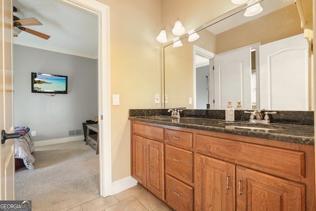 bathroom with crown molding, tile patterned flooring, ceiling fan, and vanity