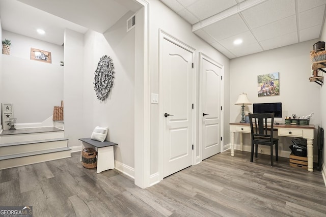 office space with hardwood / wood-style floors and a drop ceiling