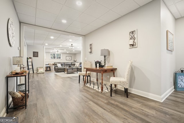 interior space with hardwood / wood-style flooring and a drop ceiling