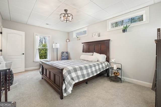 carpeted bedroom with a drop ceiling