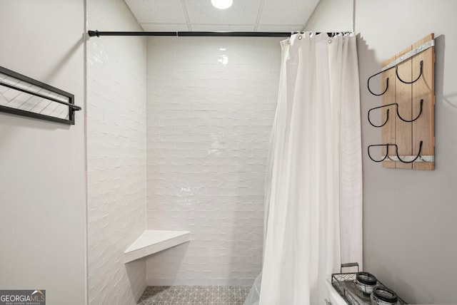 bathroom with a paneled ceiling and a shower with shower curtain