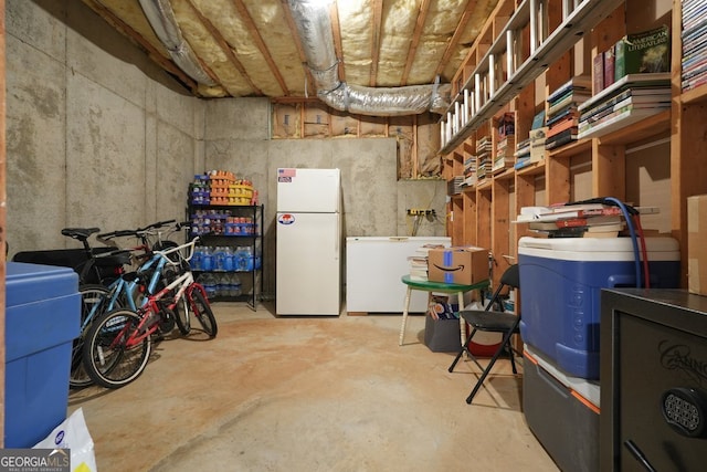 basement with fridge and white refrigerator