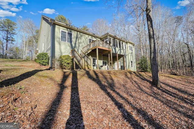 back of house featuring a deck