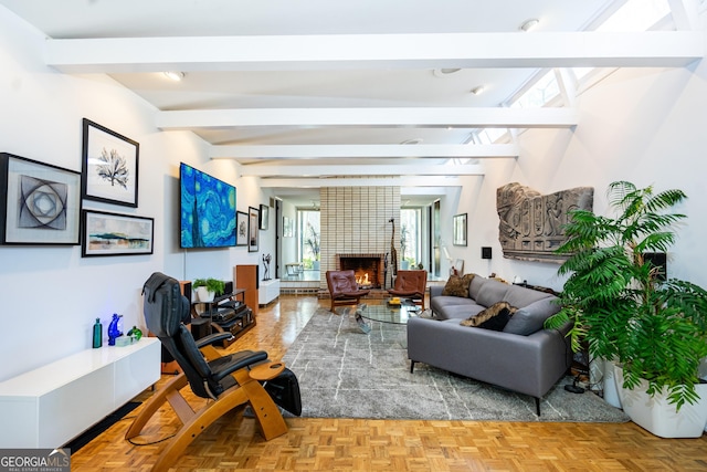 living room featuring a fireplace, parquet flooring, and beamed ceiling