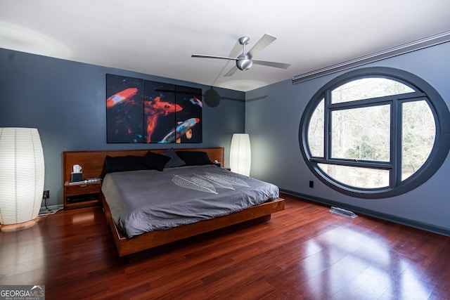 bedroom with ceiling fan and dark hardwood / wood-style floors