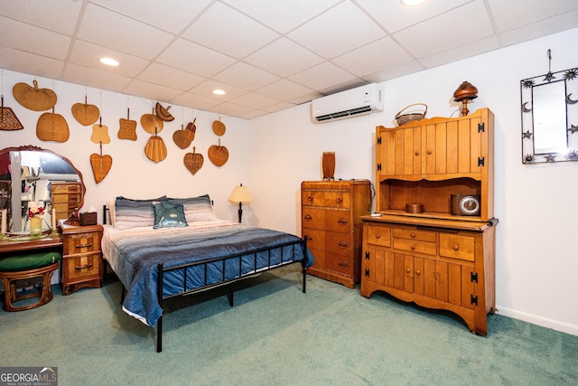 carpeted bedroom featuring a paneled ceiling and an AC wall unit