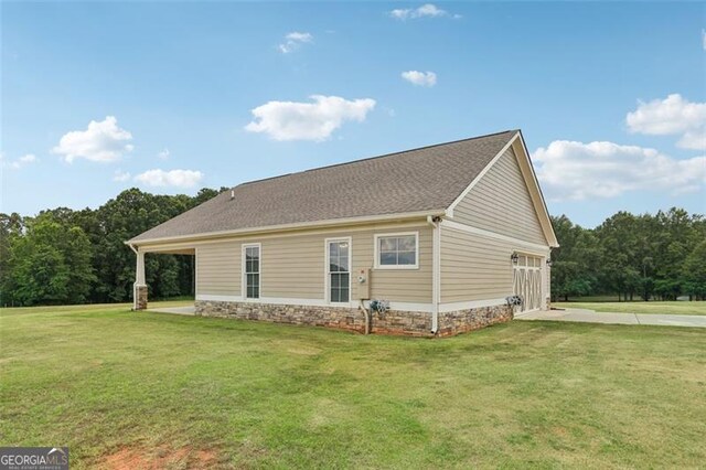 view of home's exterior with a yard