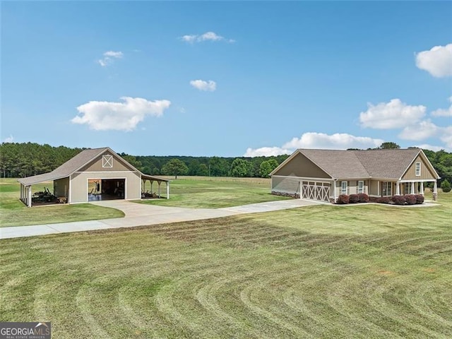 view of front of house featuring a garage, an outbuilding, a carport, and a front lawn