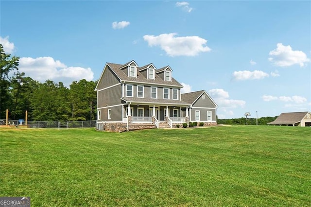 back of house featuring a yard and covered porch