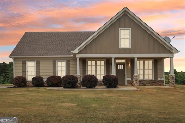 view of front facade featuring a porch and a lawn